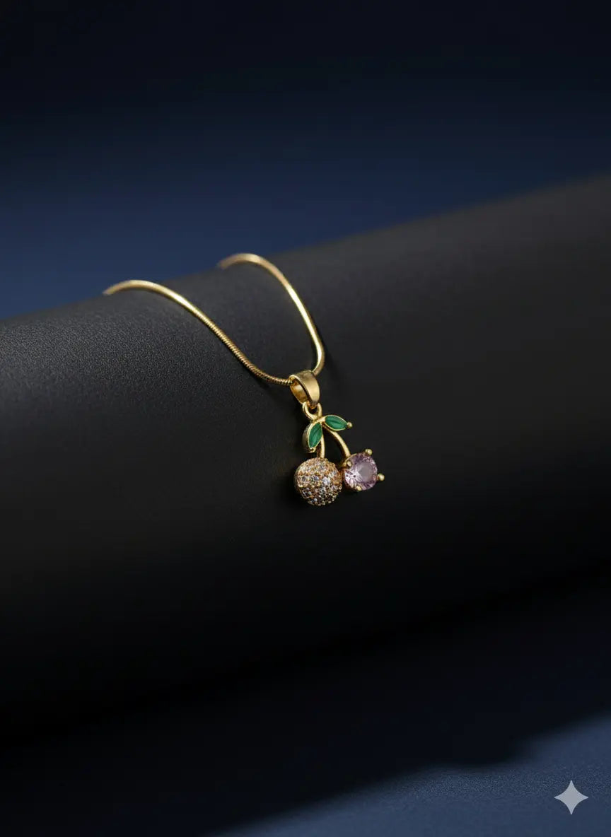 Gold necklace with small pineapple pendant featuring green enamel leaves and textured body.