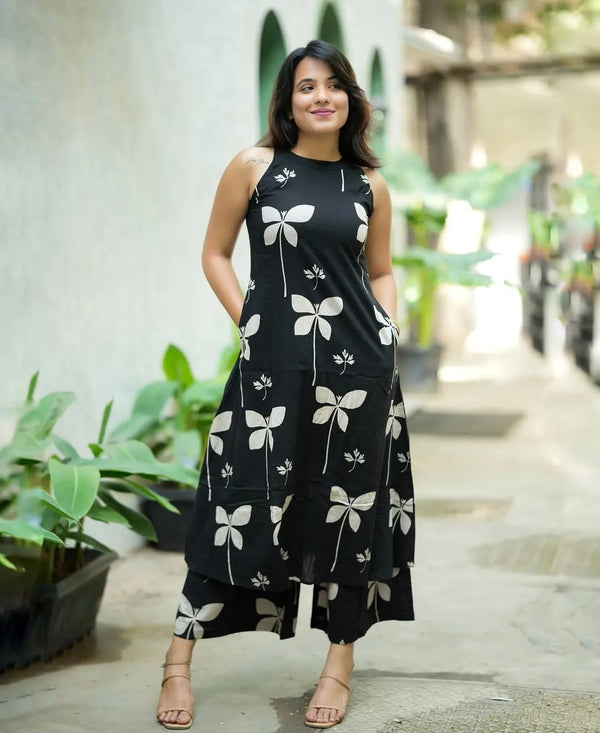 Black sleeveless palazzo set with white floral print and wide-leg pants.