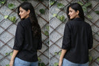Black cotton shirt with three-quarter sleeves and floral embroidery on front and back yoke, worn with jeans.