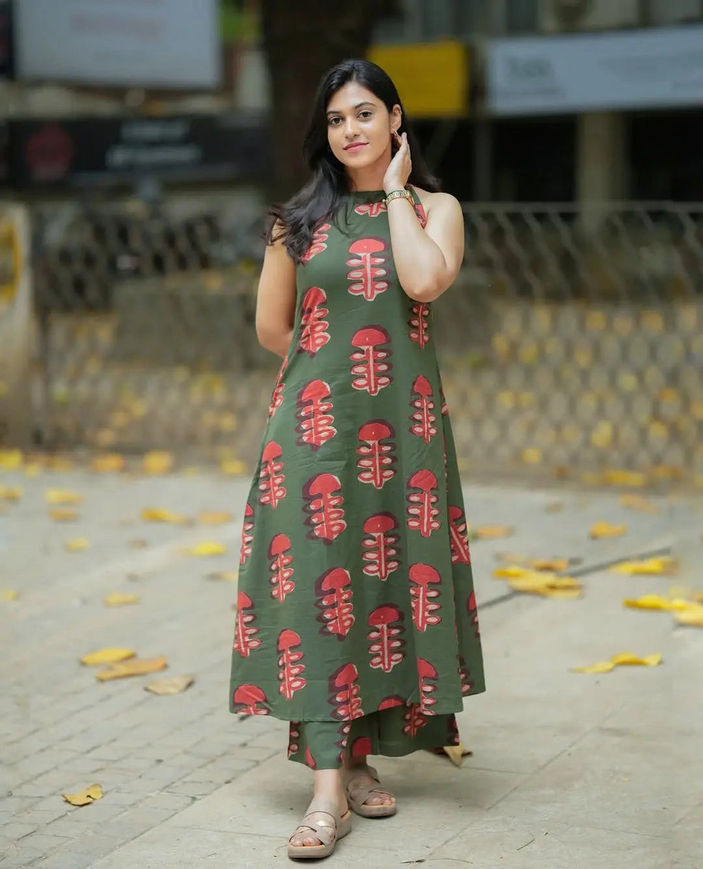 Women’s olive green sleeveless kurti with red leaf print paired with matching wide-leg palazzo pants.