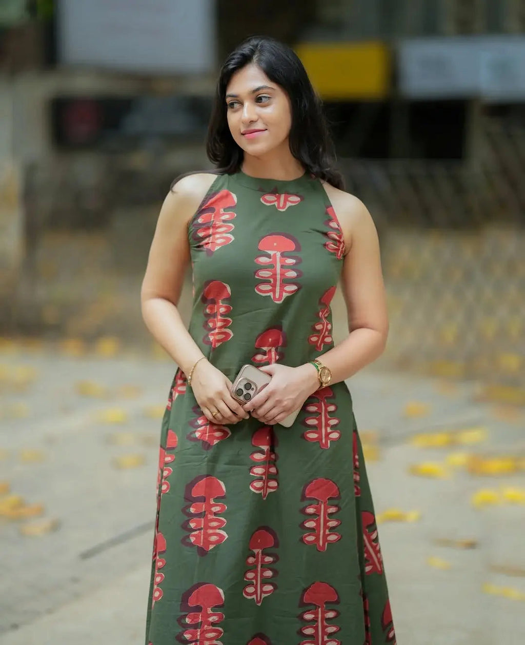 Sleeveless olive green kurti with red leafy print paired with matching palazzo pants.