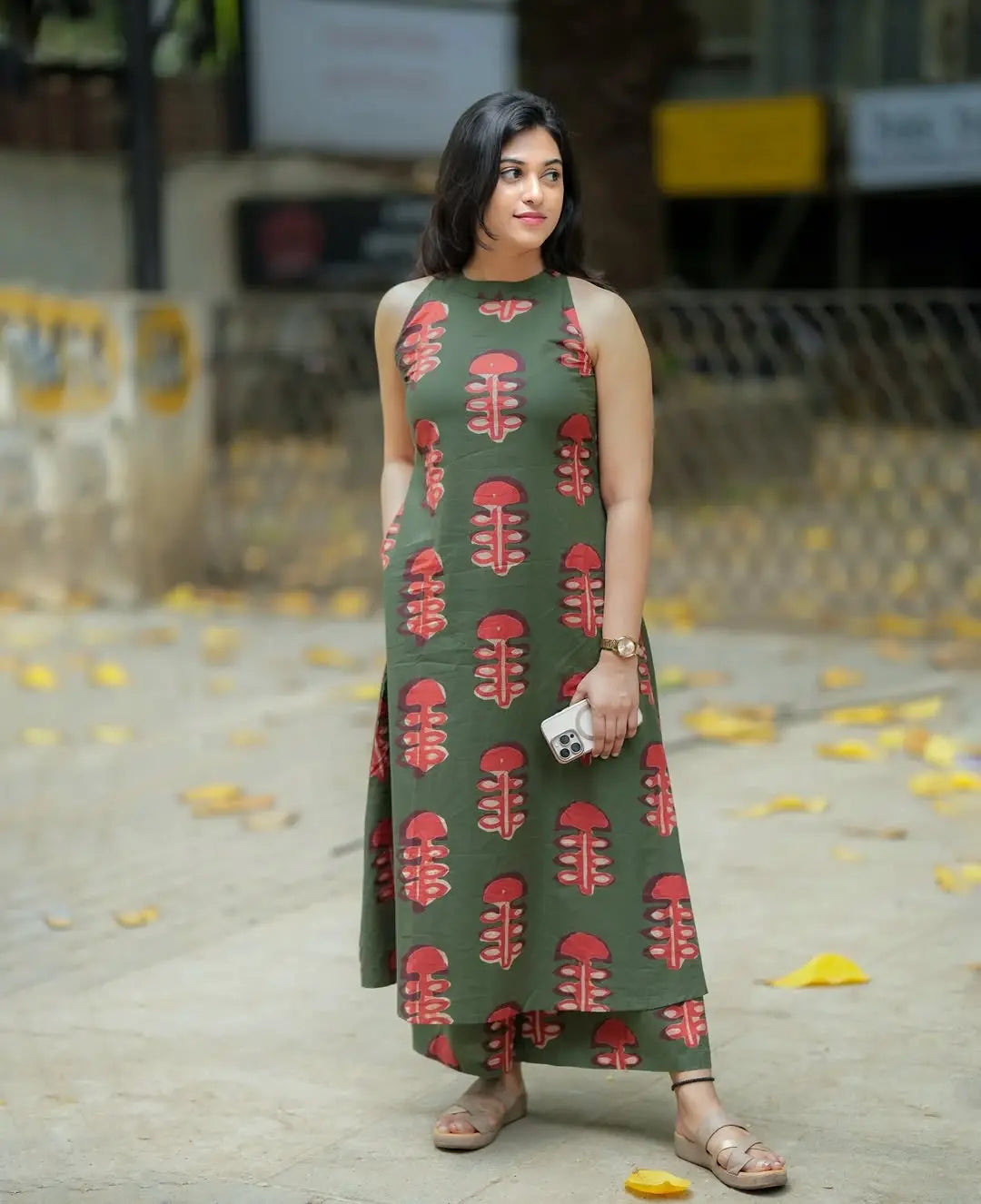 Sleeveless olive green kurti with red leaf print paired with matching palazzo pants.