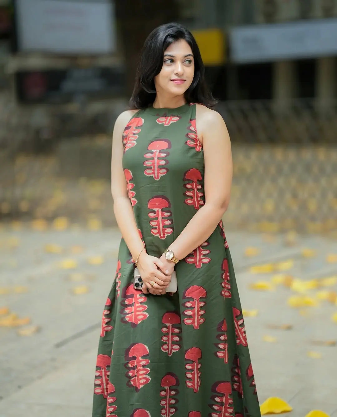 Sleeveless olive green kurti with red leaf prints paired with matching palazzo pants.