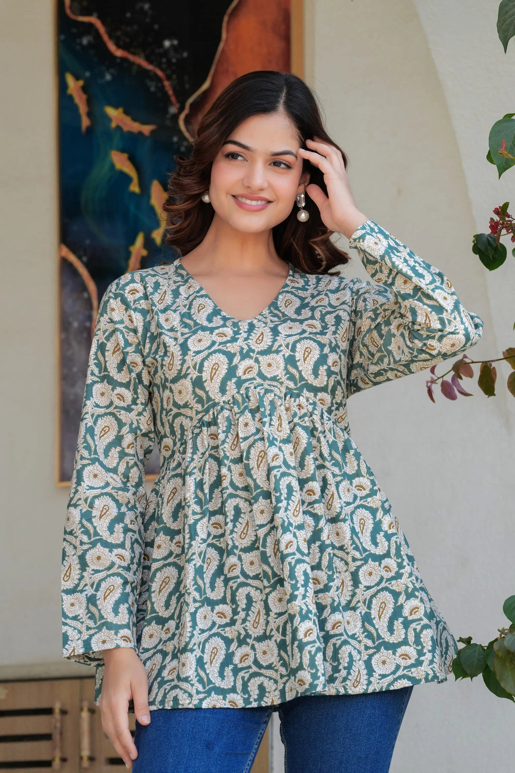 Green paisley printed long kurti top with flared silhouette and long sleeves.