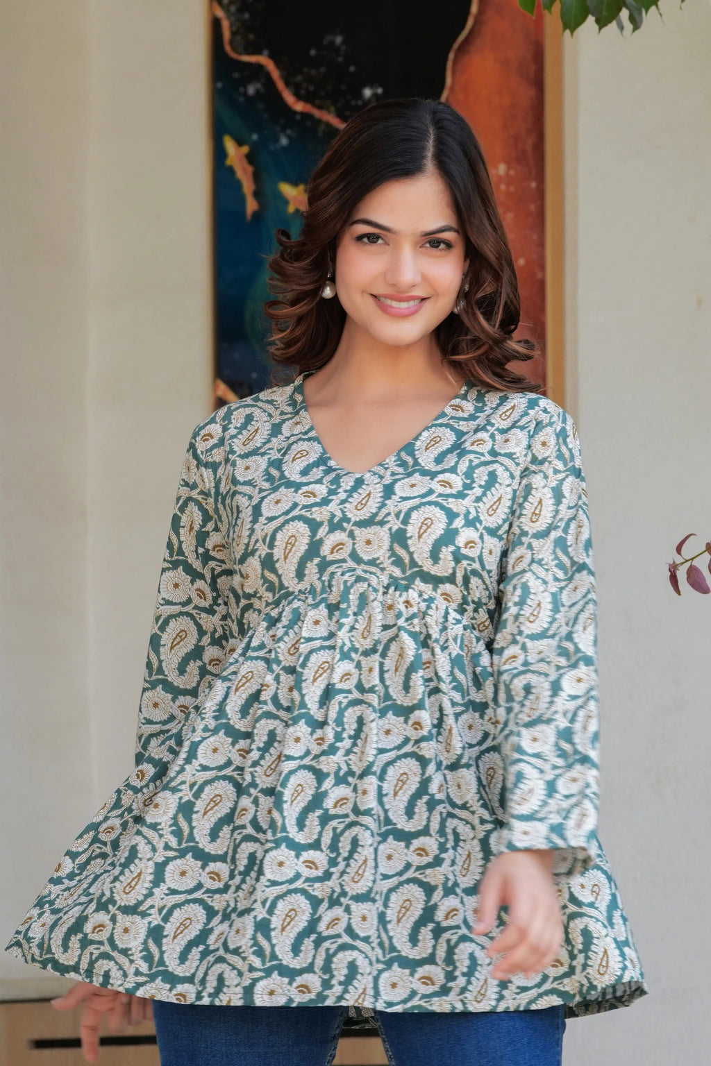Green paisley printed long kurti top with flared hem and V-neck, worn by model.
