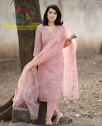 Pink embroidered traditional kurta with matching pants and sheer dupatta worn by model outdoors.