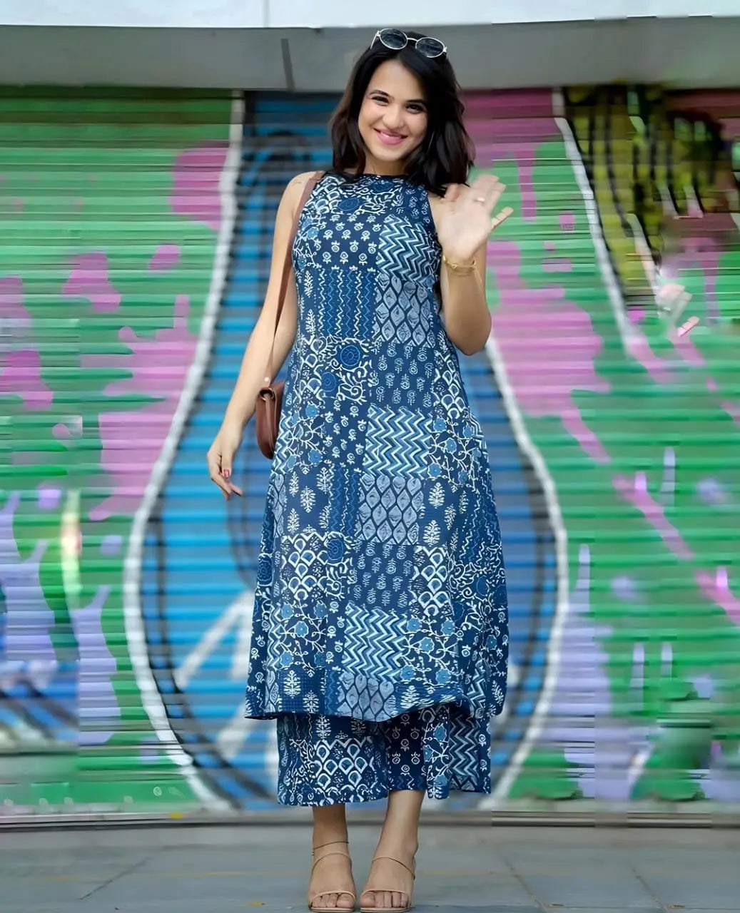 Blue sleeveless printed kurti with high-low hem paired with matching palazzo pants.