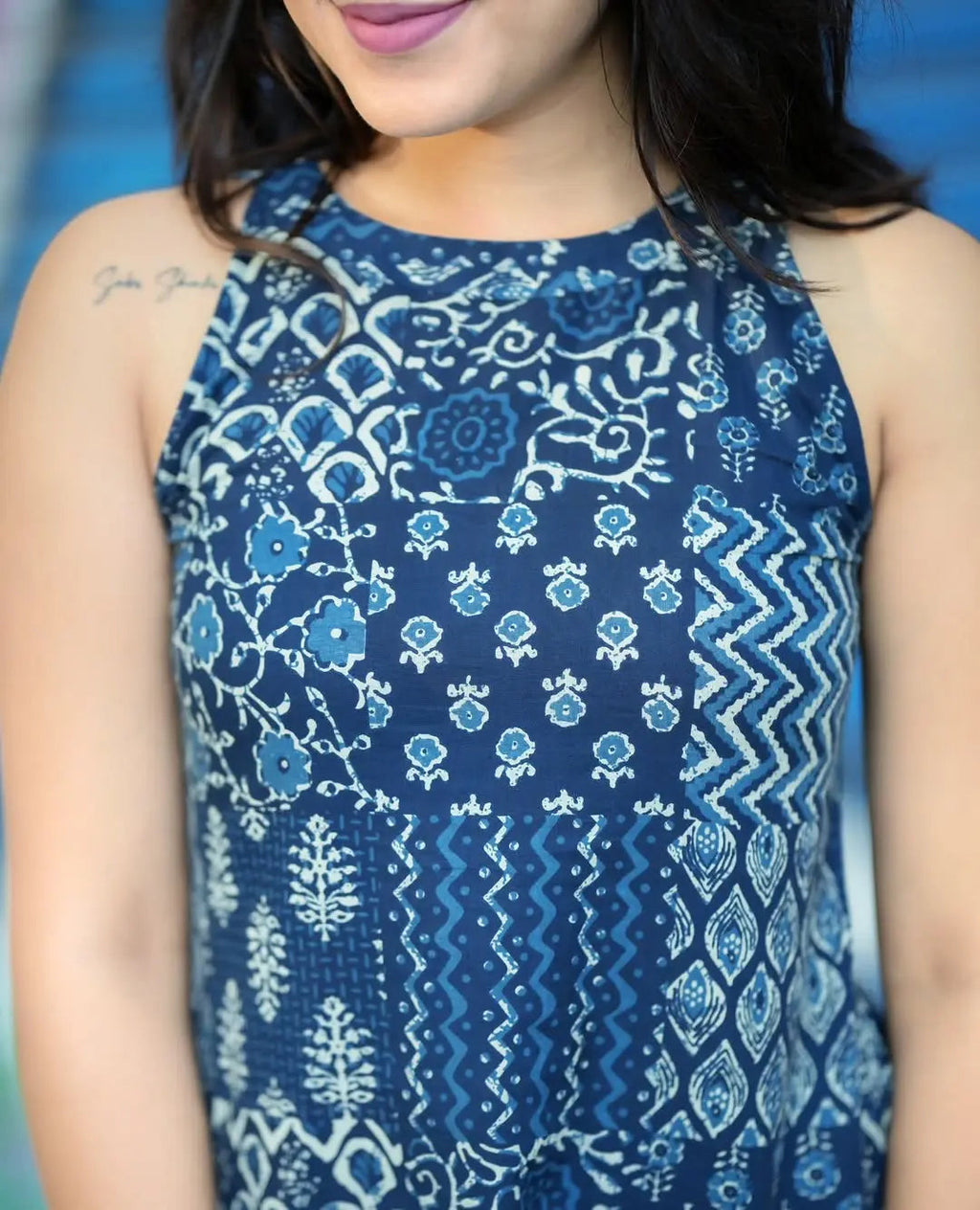 Navy blue sleeveless kurti with white floral and geometric prints paired with matching palazzo pants.