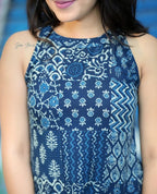 Navy blue sleeveless kurti with white floral and geometric prints paired with matching palazzo pants.