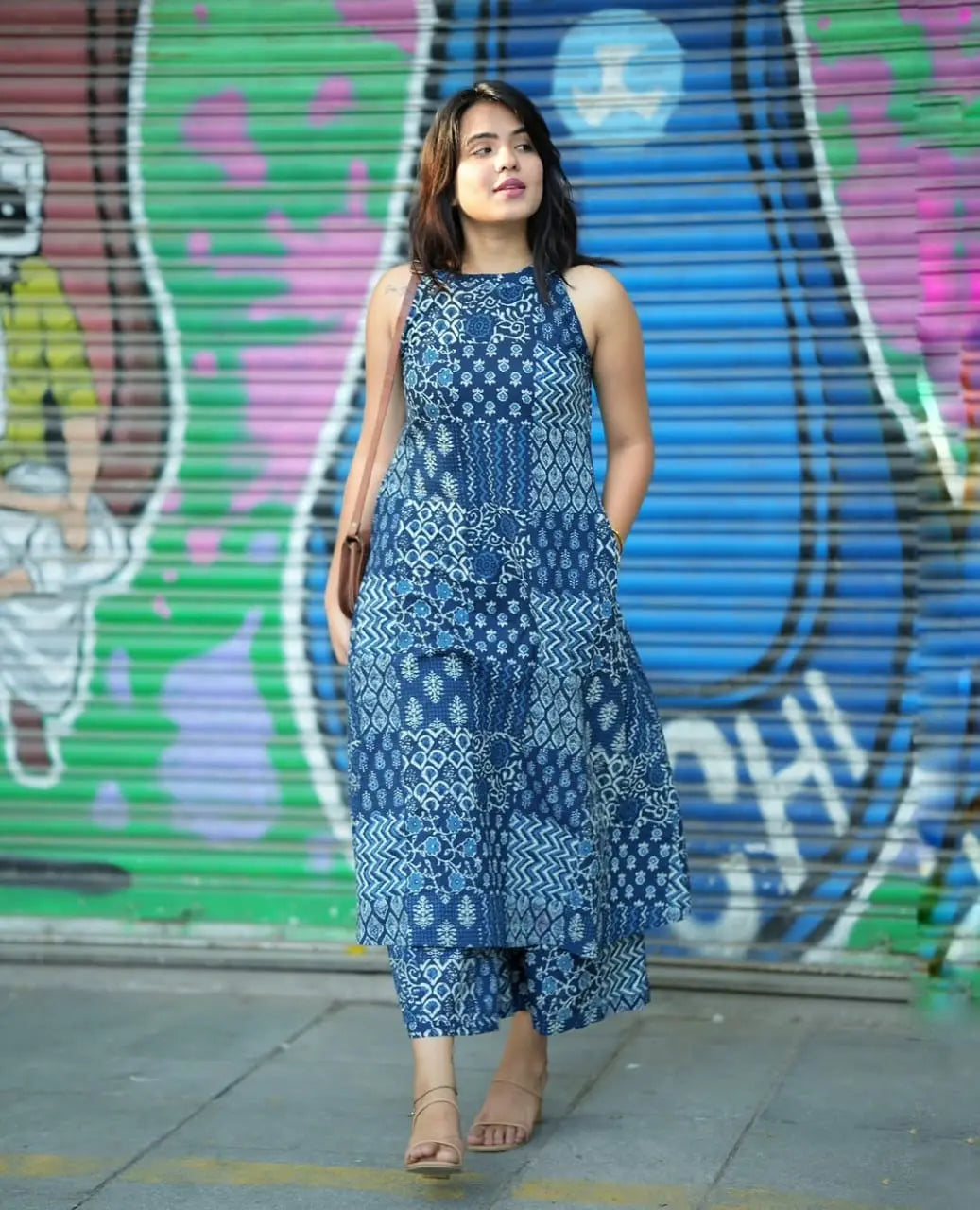 Sleeveless blue printed kurti with round neckline and side pockets paired with matching palazzo pants.