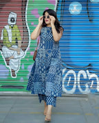 Blue ethnic printed sleeveless kurti with matching palazzo pants styled with sunglasses and beige heels.