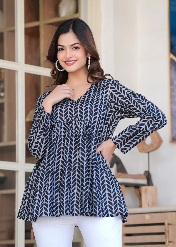 Black and white printed long kurti top with full sleeves and V-neck, styled as casual ethnic wear.