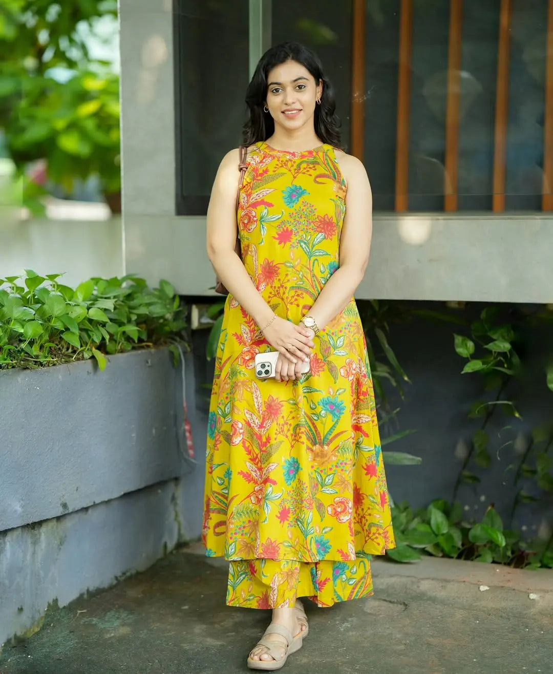 Yellow sleeveless kuera set with vibrant floral prints and matching cropped pants.