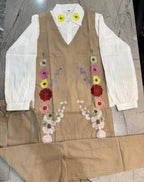 Beige corset-style dress with floral embroidery and white puffed long sleeves.
