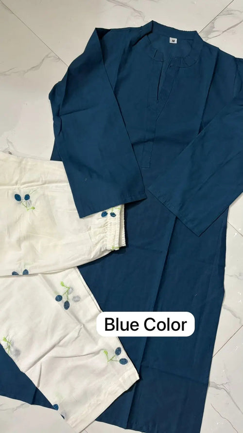 Blue corset with long sleeves and button details paired with light-colored pants featuring embroidered accents.