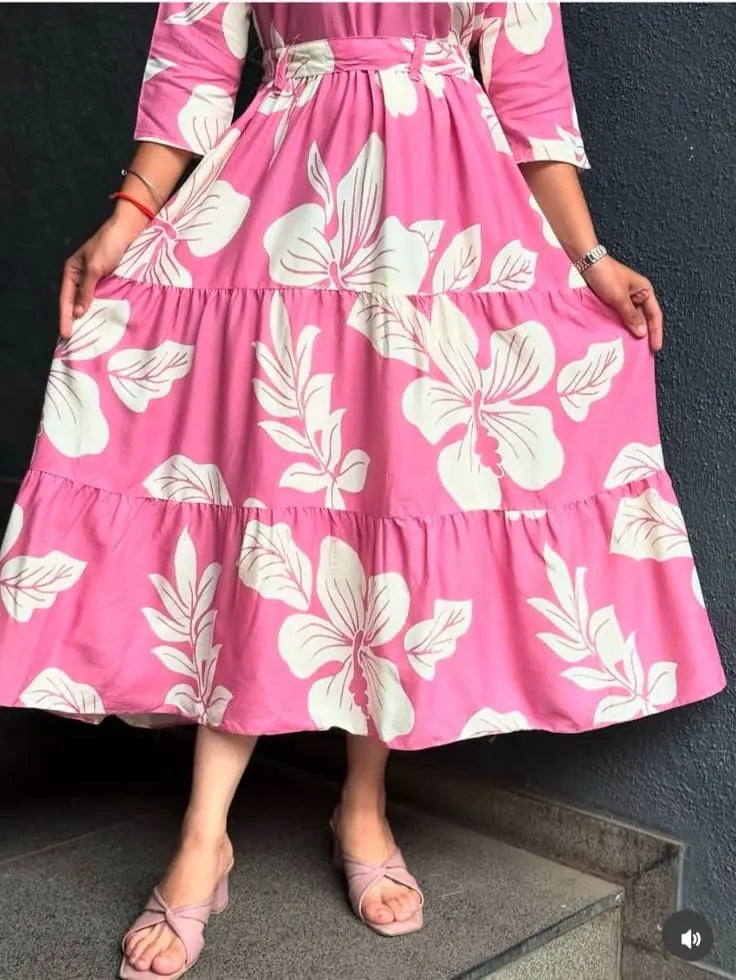 Pink short dress with large white floral print and three-quarter sleeves.