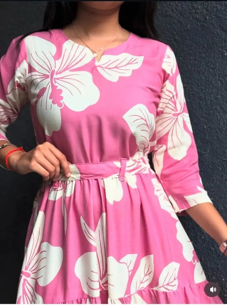 Pink short dress with white floral print and three-quarter sleeves, cinched waist detail.