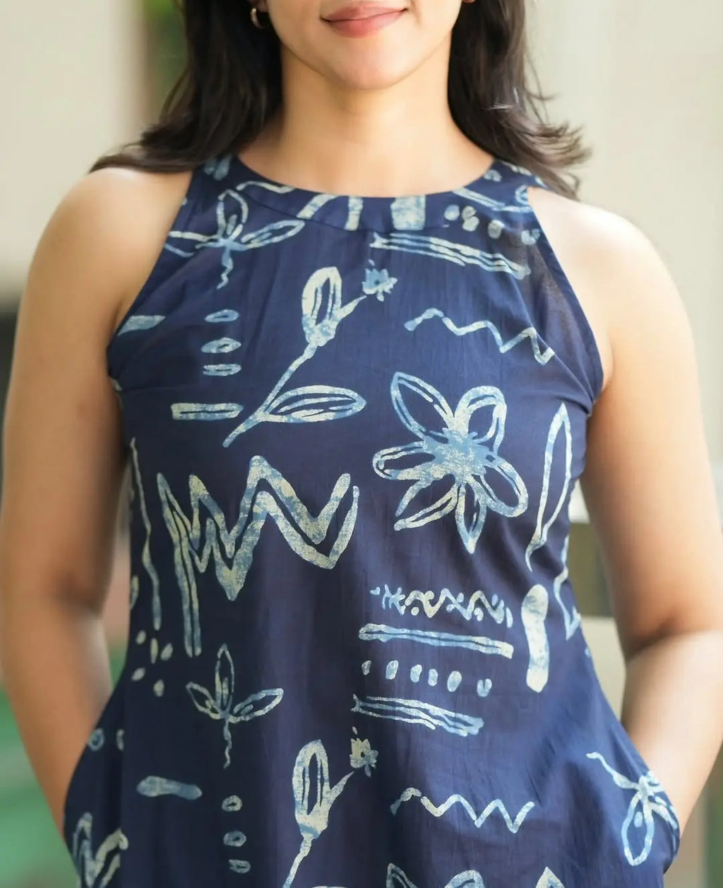 Navy blue sleeveless top with light blue abstract floral and zigzag print.