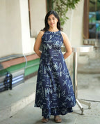 Navy blue sleeveless maxi dress with abstract white line art designs and side pockets.