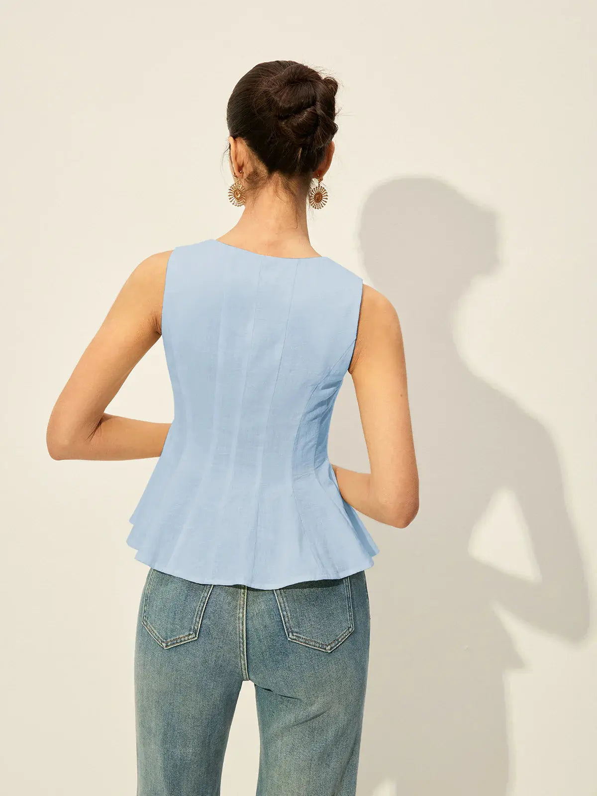 Light blue sleeveless peplum top with square neck and button-front detail, shown from back.
