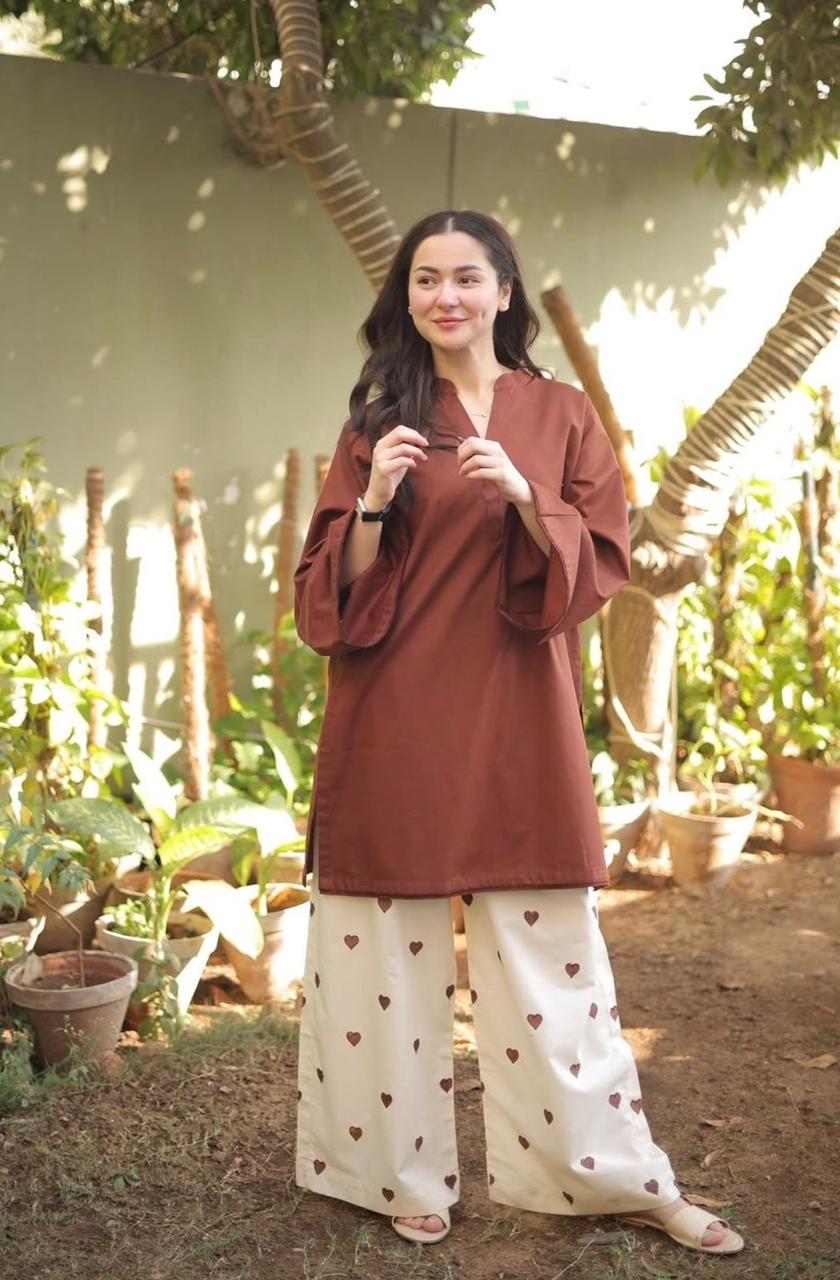 Brown long-sleeve tunic paired with white wide-leg pants featuring brown floral prints.
