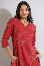 Red rayon kurta with white floral print, three-quarter sleeves, and side pockets.