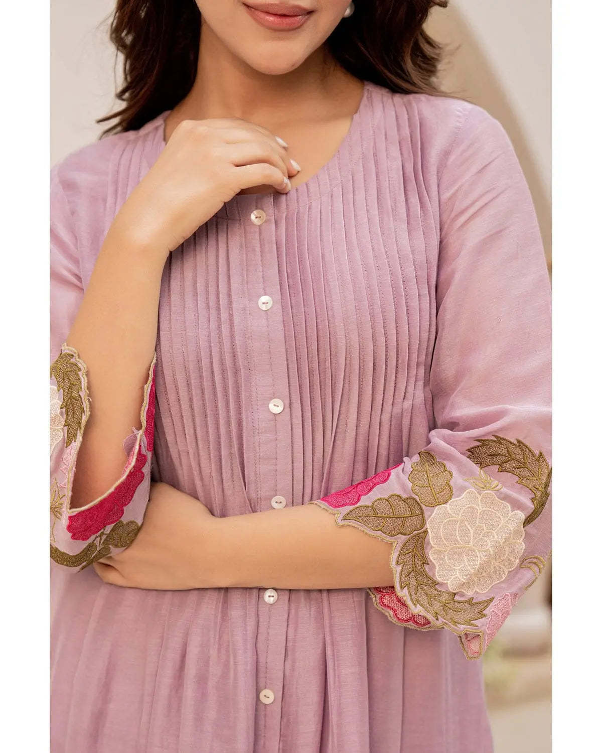 Lavender cotton kurta with vertical pleats and floral embroidery on bell sleeves, paired with matching pants.
