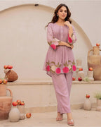 Lavender cotton kurta with floral embroidery and matching straight pants, worn with pink bangles.