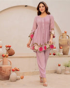 Lavender cotton kurta with pink floral embroidery and matching straight pants.