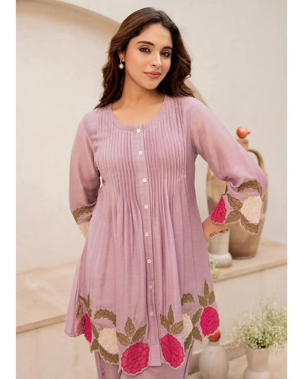 Lavender cotton kurta with floral embroidery and button-down front, paired with matching pants.