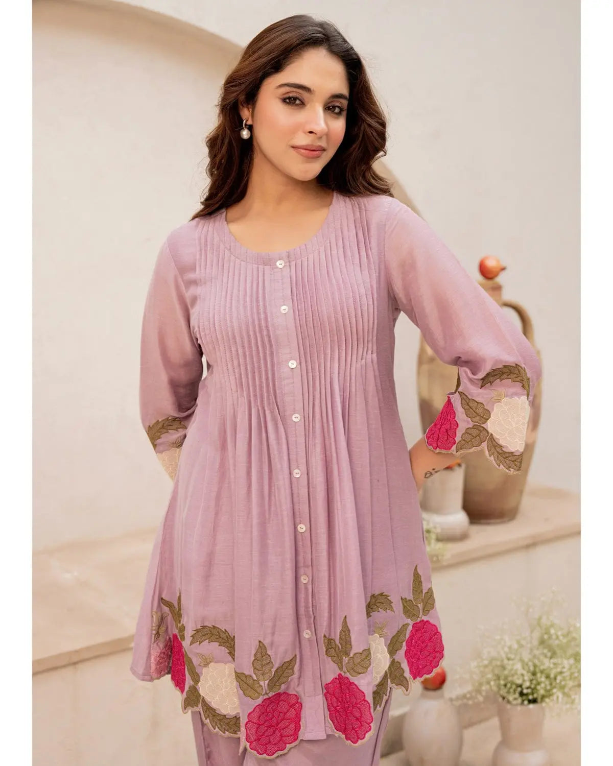 Lavender cotton kurta with floral embroidery and button-down front, paired with matching pants.