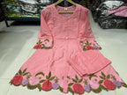 Peach cotton kurta with floral embroidery on sleeves and hem, paired with matching straight pants.