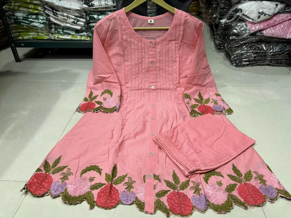 Peach cotton kurta with floral embroidery on sleeves and hem, paired with matching straight pants.