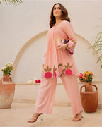Peach cotton kurta with floral embroidery paired with matching wide-leg pants and nude heels.