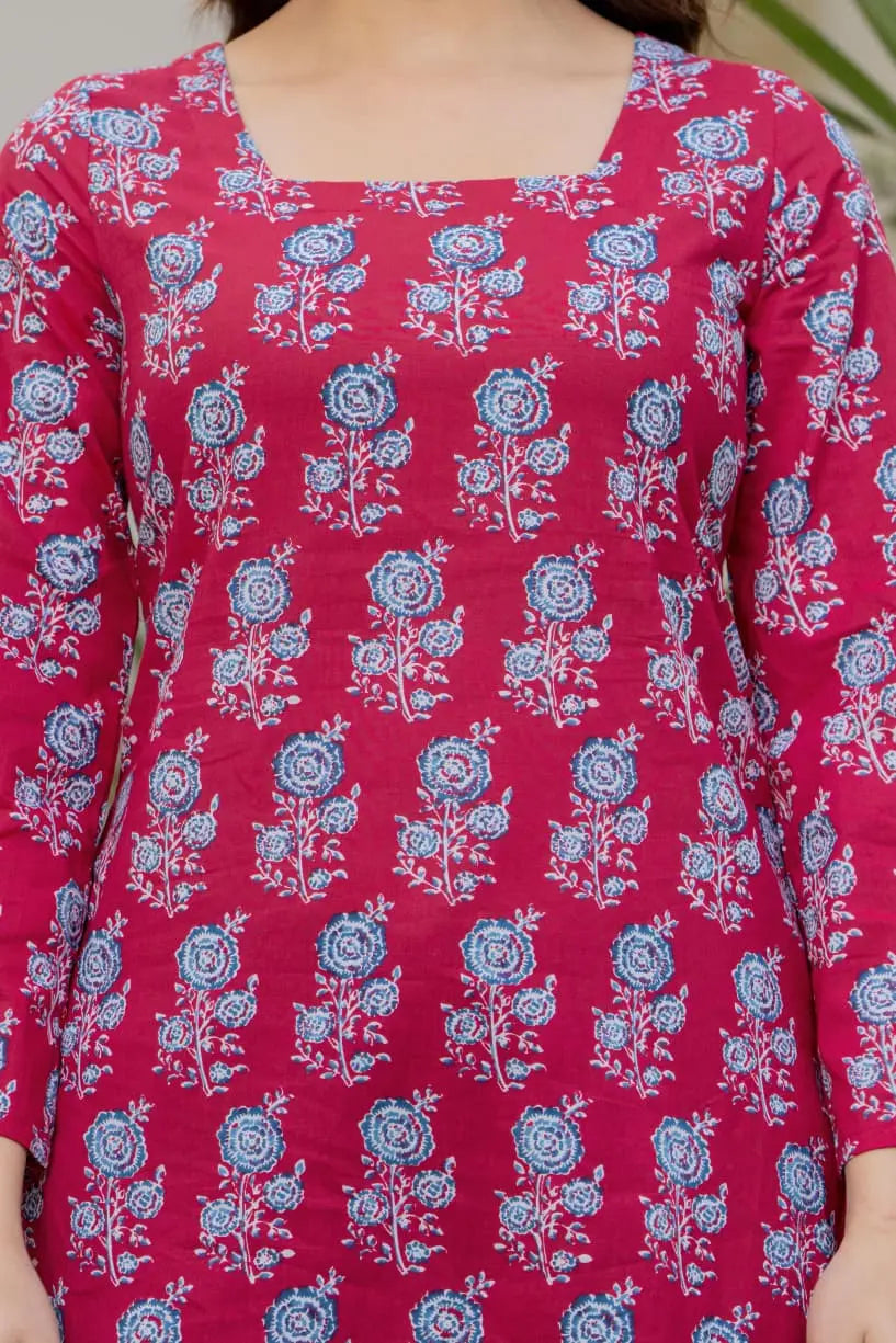 Pink cotton A-line kurti with blue floral print, square neckline, and flared sleeves.