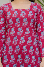 Pink cotton A-line kurti with blue floral print, square neckline, and flared sleeves.