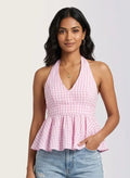 Pink and white checkered halter neck top with peplum waist, paired with light blue jeans.