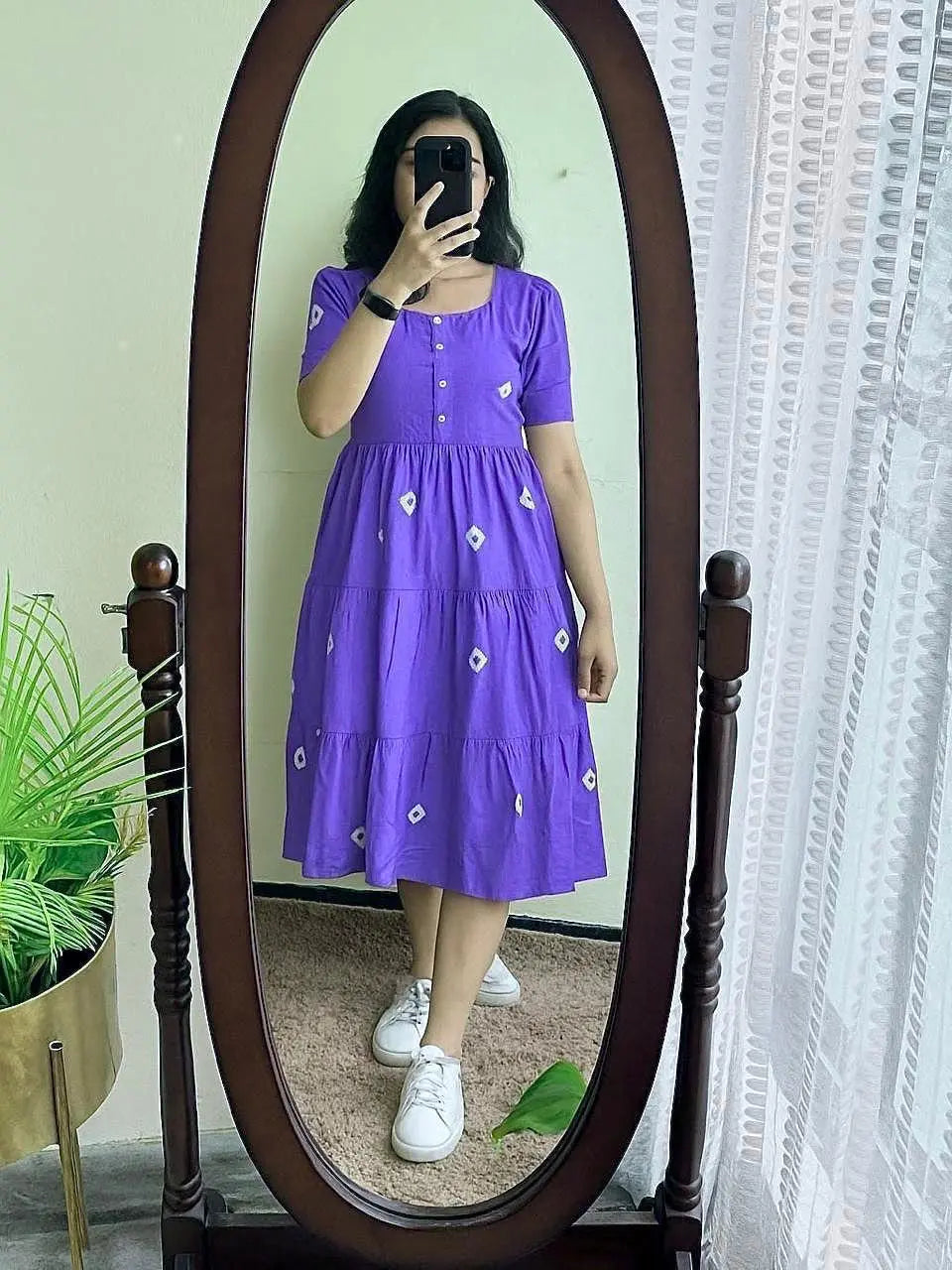 Purple midi dress with short sleeves, button front, and white floral embroidery paired with white sneakers.