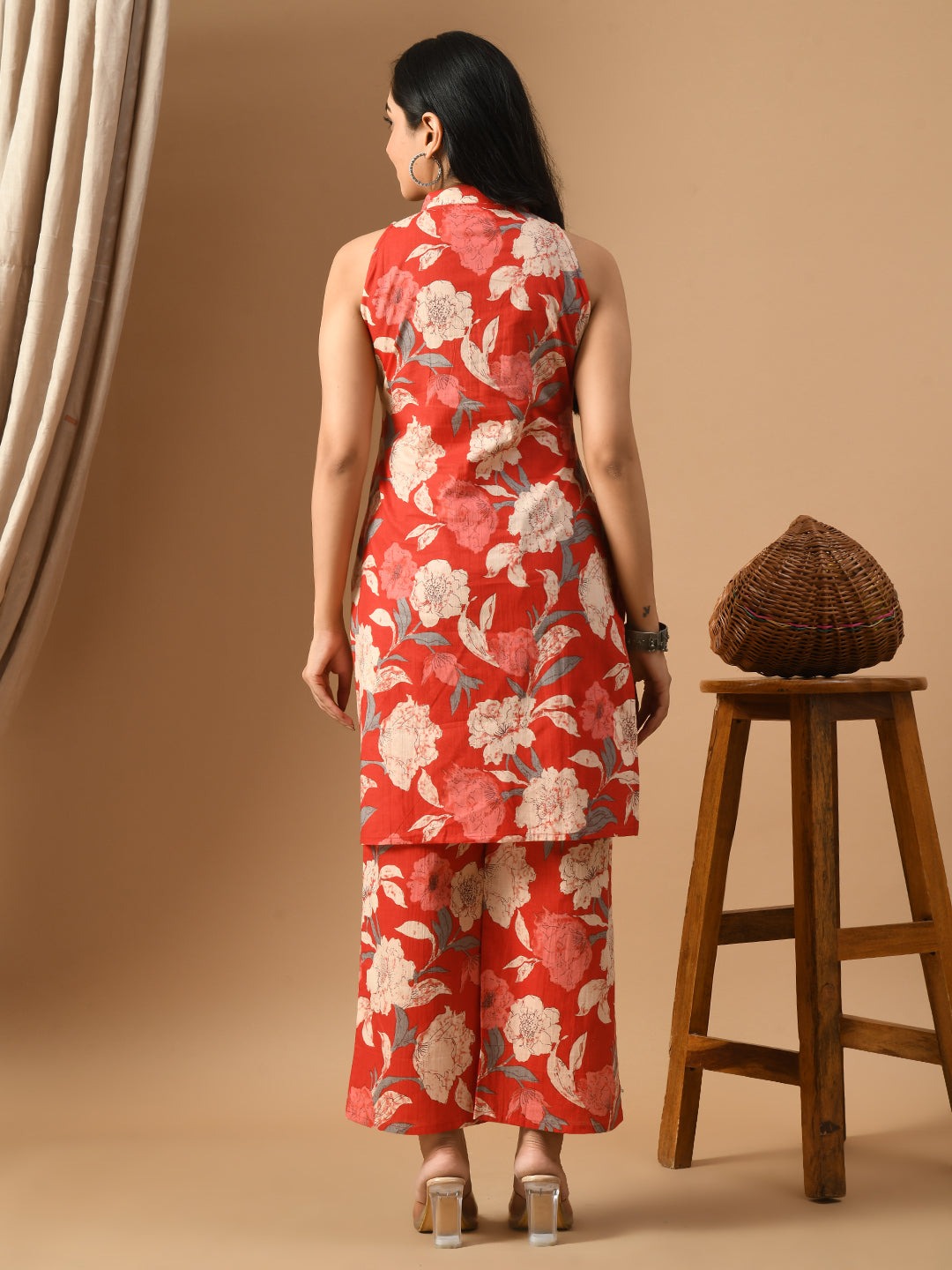 Rust orange cotton kurta with white floral print and matching wide-leg pants, sleeveless design.