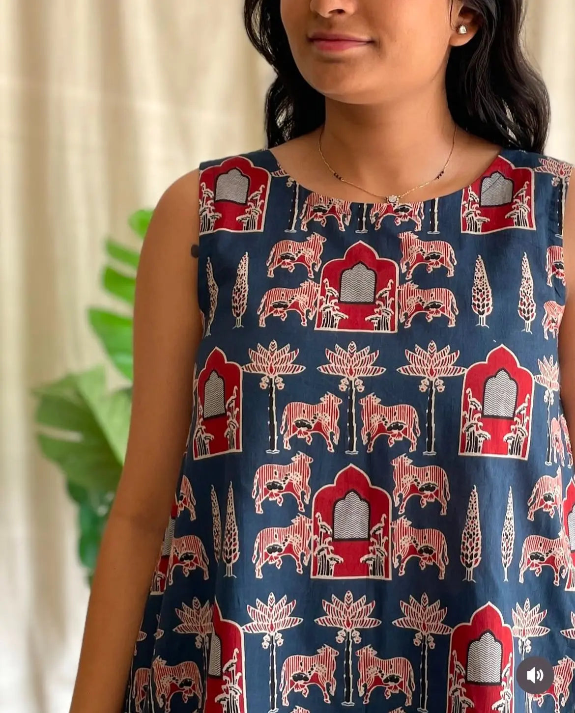 Sleeveless navy blue top with red and beige traditional block print patterns.
