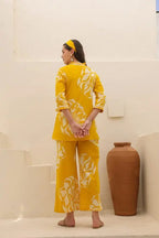 Mustard yellow floral printed long-sleeve top and wide-leg pants co-ord set with matching headband.