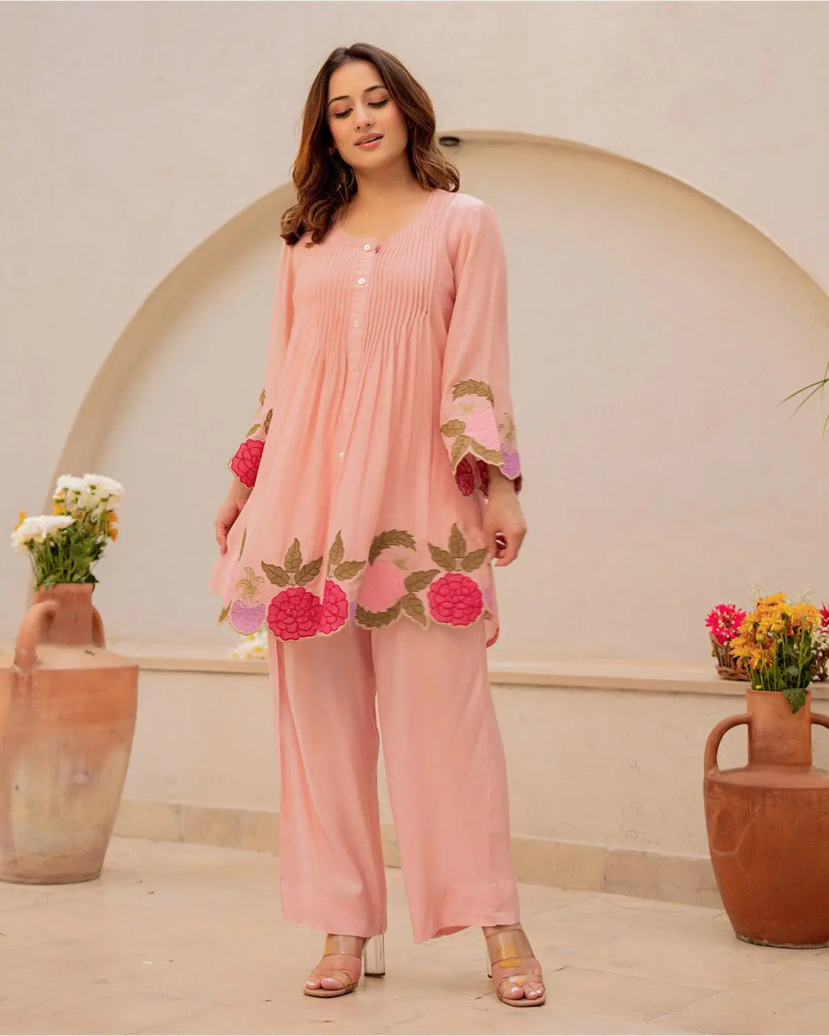 Peach cotton kurta with floral embroidery and matching wide-leg pants on model.