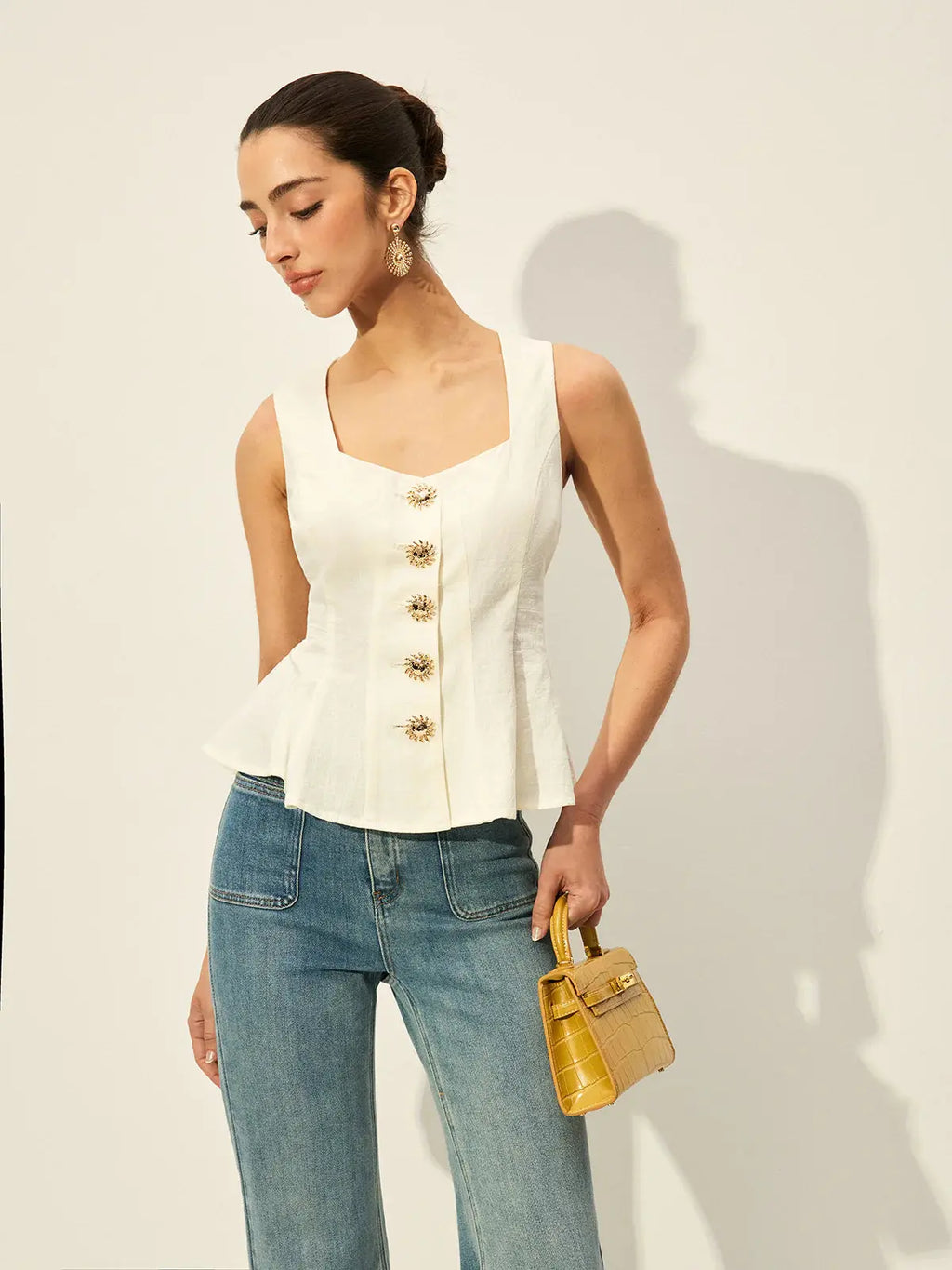 White square neck peplum top with front wooden buttons and wide shoulder straps.